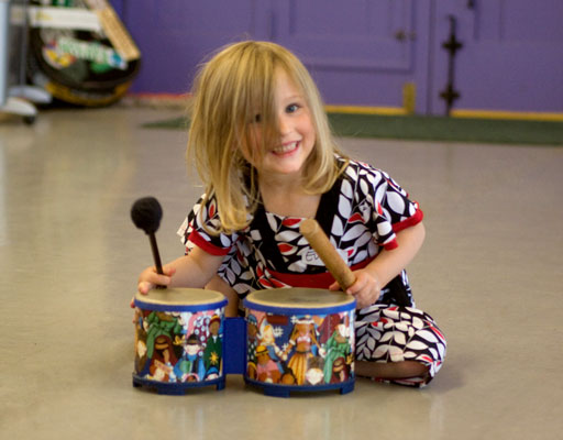 Little Girl playing Drum